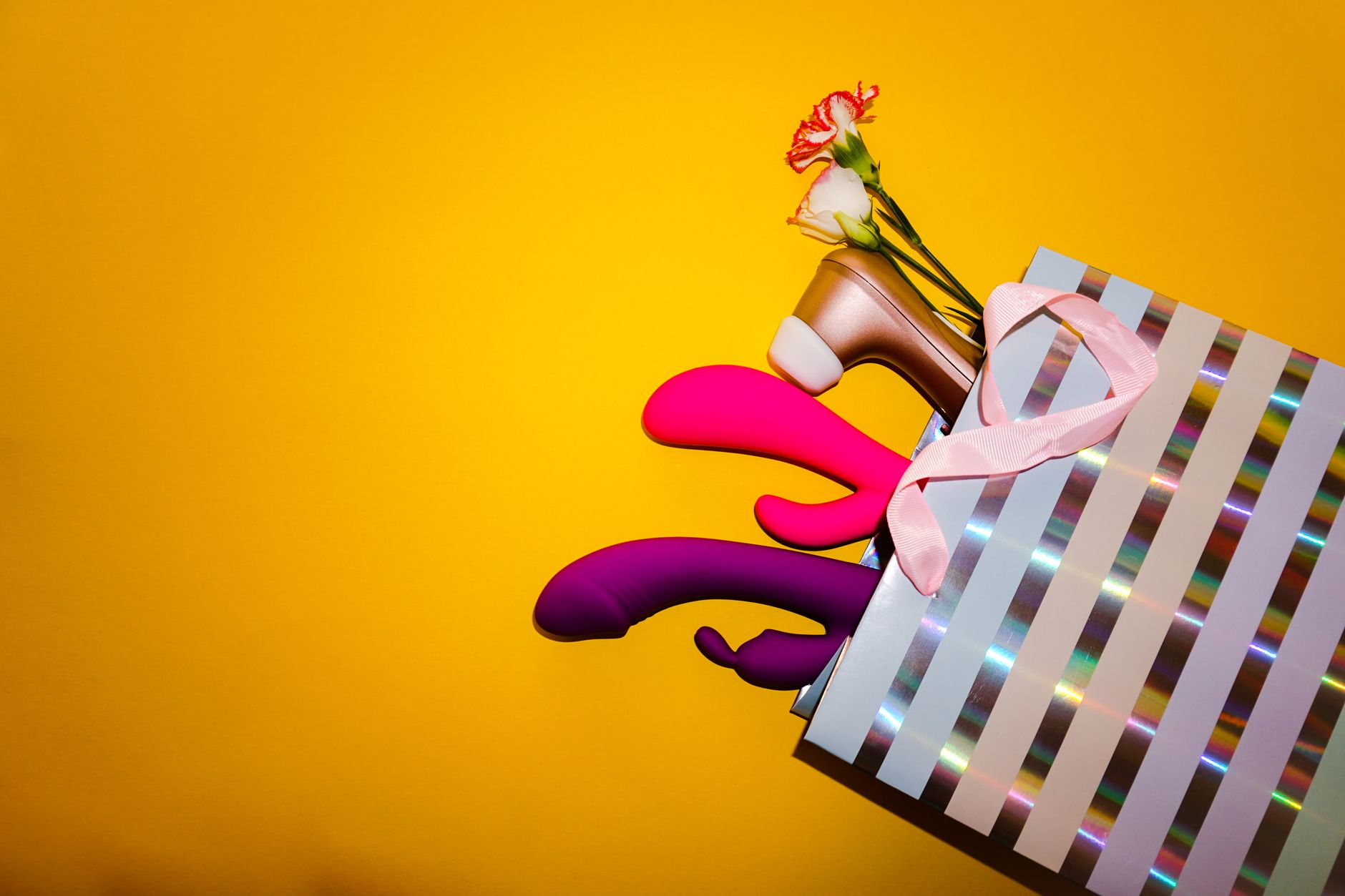 Vibrant collection of various adult toys on a black tray, showcasing diverse shapes and colors for partnered pleasure
